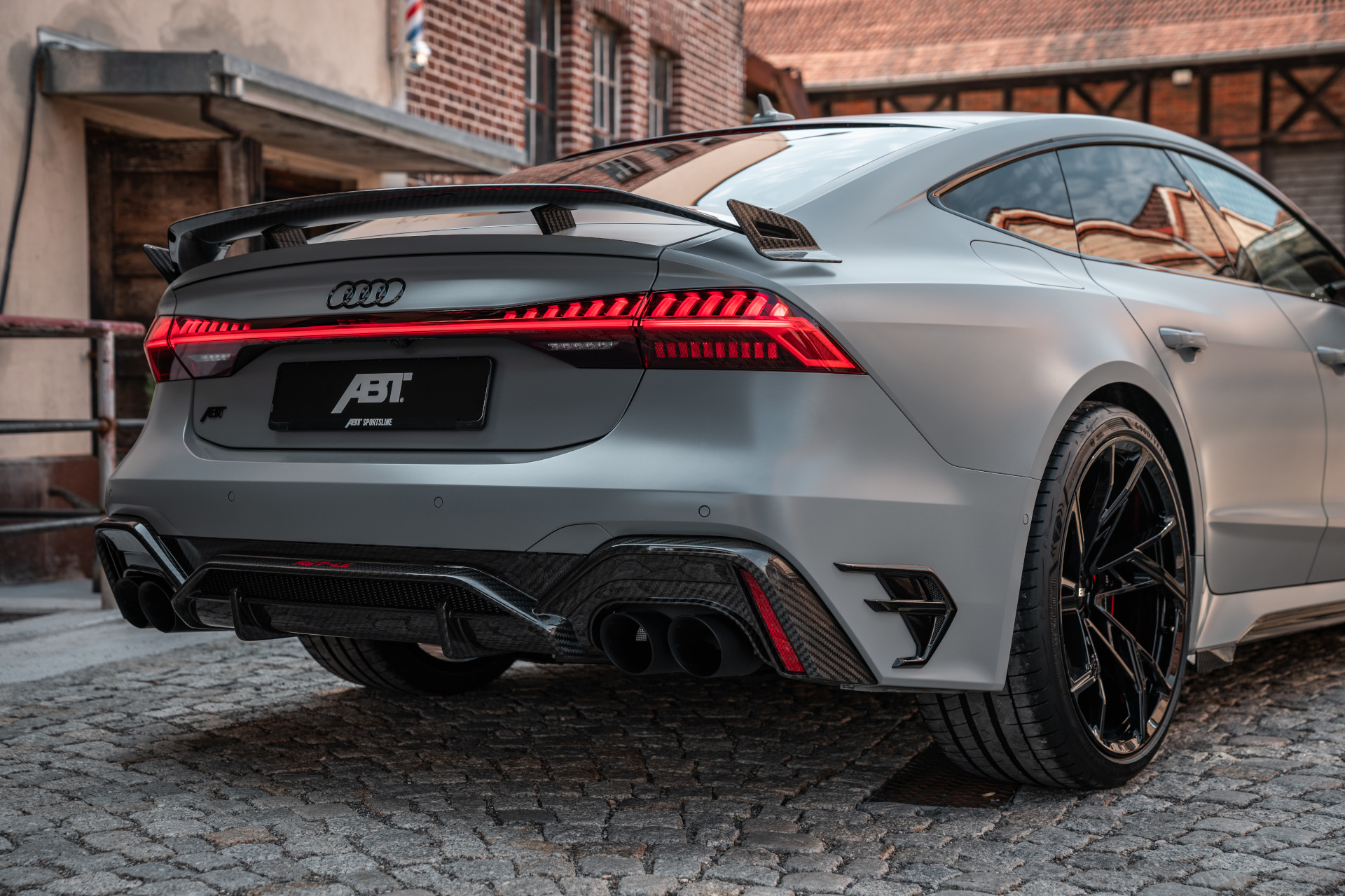 Grey RS7-LE from a bird's eye view from behind in a smoky hall 